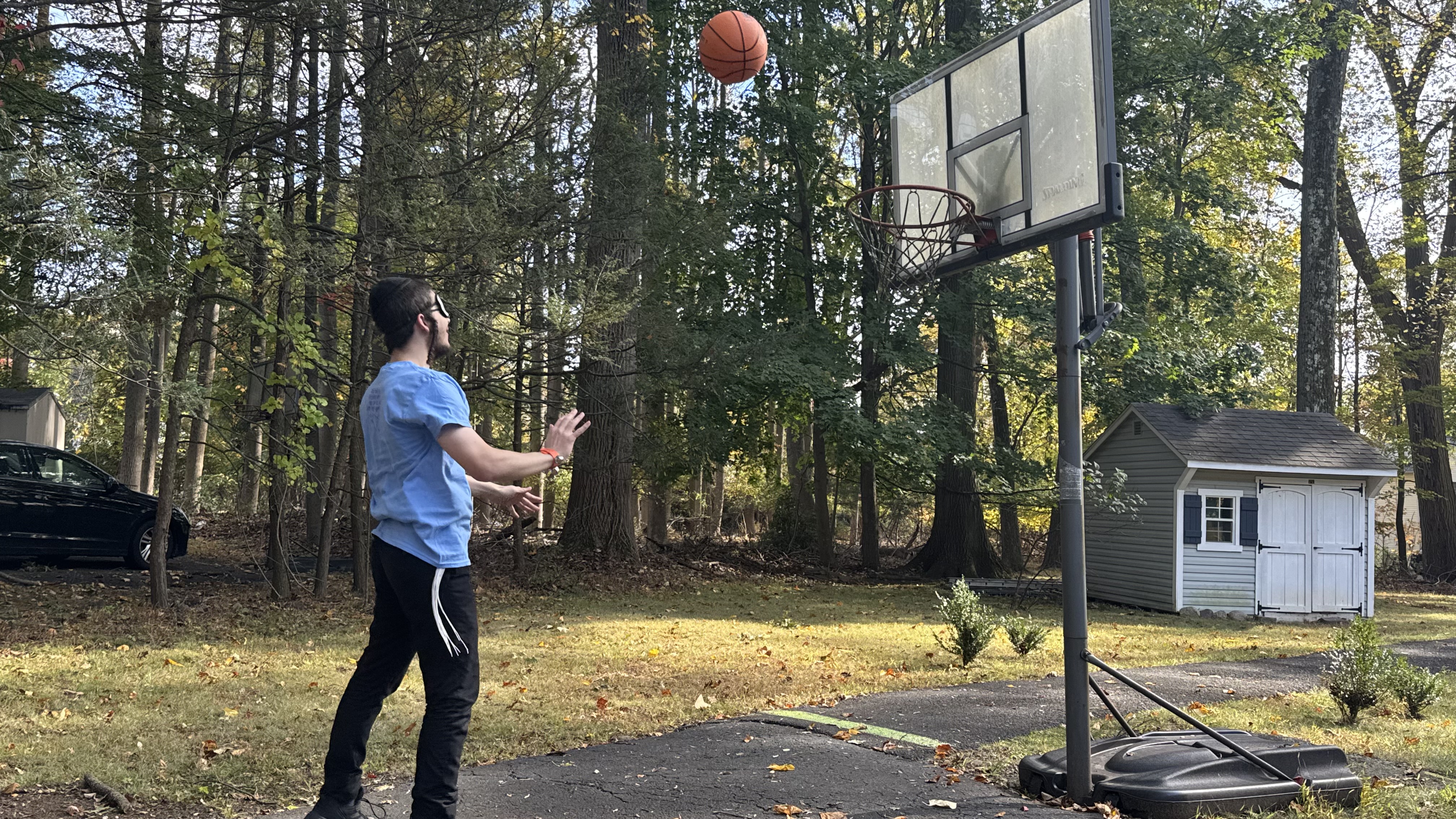 A camper throwing a basketball toward an audio-equipped hoop